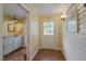 Hallway with access to laundry room with a utility sink and exterior door at 531 N Main St, Graham, NC 27253
