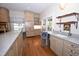 Bright eat-in kitchen featuring granite countertops, stainless appliances, and hardwood flooring at 531 N Main St, Graham, NC 27253