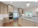 Bright kitchen features stone countertops, stainless steel appliances, window seat, and hardwood floors at 531 N Main St, Graham, NC 27253