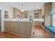 Kitchen featuring a center island, stone countertops, custom cabinets, and stainless steel appliances at 531 N Main St, Graham, NC 27253