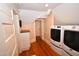 Laundry room with front load washer/dryer, built in cabinets, butcher block countertop and hardwood flooring at 531 N Main St, Graham, NC 27253