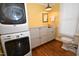 Well-equipped laundry room with stacked washer and dryer, cabinets, and countertop at 531 N Main St, Graham, NC 27253