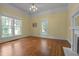 Cozy living room with hardwood floors, fireplace, and natural light from the windows at 531 N Main St, Graham, NC 27253