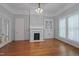 Living room featuring hardwood floors, fireplace, and built-in display cabinet at 531 N Main St, Graham, NC 27253