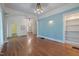 Spacious living room with blue textured walls, wood floors, and built-in shelving at 531 N Main St, Graham, NC 27253