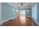 Bright living room featuring hardwood floors, textured blue walls and a vintage chandelier at 531 N Main St, Graham, NC 27253