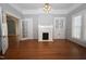 Beautiful living room featuring hardwood floors, fireplace, and built-in cabinet at 531 N Main St, Graham, NC 27253