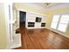 Spacious living room with hardwood floors, built-in shelving, and decorative fireplace at 531 N Main St, Graham, NC 27253