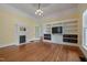 Living room showcasing a fireplace with built-ins and a large entertainment center at 531 N Main St, Graham, NC 27253