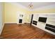 Comfortable living room with hardwood floors, built-in shelving, and fireplace at 531 N Main St, Graham, NC 27253