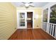 Screened in porch with wood floors and door leading to kitchen at 531 N Main St, Graham, NC 27253