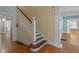 Staircase in entryway with hardwood floors and detailed wood trim at 531 N Main St, Graham, NC 27253