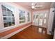 Inviting sunroom featuring hardwood floors, pastel pink walls, and French doors at 531 N Main St, Graham, NC 27253