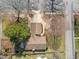 Charming single-story home featuring a brick exterior, mature trees, and a well-manicured front yard at 5400 Cedarwood Dr, Raleigh, NC 27609