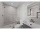 Modern bathroom with a glass shower, tiled walls, and a sleek vanity at 5400 Cedarwood Dr, Raleigh, NC 27609
