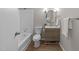 Renovated bathroom features a shower-tub, tile backsplash, and a wood vanity with a modern mirror at 5400 Cedarwood Dr, Raleigh, NC 27609