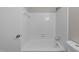 Bright bathroom features a white shower-tub and door, white wall tiles, and stainless steel fixtures at 5400 Cedarwood Dr, Raleigh, NC 27609
