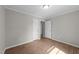 A well lit room featuring hardwood floors and access to a closet and bathroom at 5400 Cedarwood Dr, Raleigh, NC 27609