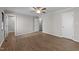 A spacious bedroom featuring modern flooring, a ceiling fan, and multiple closets at 5400 Cedarwood Dr, Raleigh, NC 27609