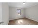 A simple bedroom with hardwood flooring, natural light, and a neutral color palette at 5400 Cedarwood Dr, Raleigh, NC 27609