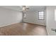 A bright bedroom with hardwood flooring, a ceiling fan, and two sunlit windows at 5400 Cedarwood Dr, Raleigh, NC 27609