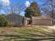 Brick exterior of a single story home with a well-manicured lawn and mature trees on a sunny day at 5400 Cedarwood Dr, Raleigh, NC 27609