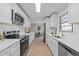 Bright kitchen features white cabinets, stainless steel appliances, and a subway tile backsplash at 5400 Cedarwood Dr, Raleigh, NC 27609