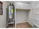 Bright laundry room features a new hot water heater, storage cabinets, and shelving at 5400 Cedarwood Dr, Raleigh, NC 27609