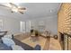 Cozy living room with a brick fireplace, neutral color scheme, and wood-look floors at 5400 Cedarwood Dr, Raleigh, NC 27609