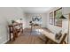 Bright home office with a modern glass desk, neutral walls, wood-look floors, and natural light from the window at 5400 Cedarwood Dr, Raleigh, NC 27609