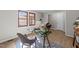 Home office featuring a glass desk, wood-look floors, and a window with natural light at 5400 Cedarwood Dr, Raleigh, NC 27609