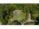 Stunning aerial view of the property showcasing the sprawling lawn, mature trees, and circular driveway at 5601 Lambshire Dr, Raleigh, NC 27612