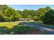 A single-story brick home with a dark gray garage door on a large lot at 5601 Lambshire Dr, Raleigh, NC 27612