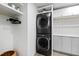 Stacked washer and dryer in a modern laundry room with white and gray cabinetry at 5601 Lambshire Dr, Raleigh, NC 27612