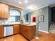 Open kitchen showcases stainless steel appliances, granite countertops, and wood cabinets at 5815 Cameo Glass Way, Raleigh, NC 27612