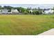 A large, grassy backyard provides an expansive outdoor space, with a fence bordering the property at 6013 Shelane Ct, Raleigh, NC 27610