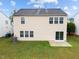 An exterior shot of a home with a green yard and a sliding glass door, offering outdoor access at 6013 Shelane Ct, Raleigh, NC 27610