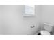 Powder room with toilet and small window at 6013 Shelane Ct, Raleigh, NC 27610