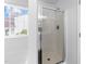 Bathroom featuring a glass shower door and window at 6013 Shelane Ct, Raleigh, NC 27610
