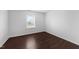 Empty bedroom with wood look flooring, neutral walls, and a window at 6013 Shelane Ct, Raleigh, NC 27610