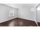 Sun-filled bedroom features hardwood floors and several windows at 6013 Shelane Ct, Raleigh, NC 27610