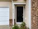 Close-up of the front door, highlighting the house number and brick accents at 6013 Shelane Ct, Raleigh, NC 27610
