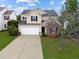 Charming two-story home with a well-manicured lawn, attached garage, and brick facade accent at 6013 Shelane Ct, Raleigh, NC 27610