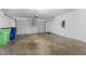 Spacious two car garage featuring a roll up door and a utility box at 6013 Shelane Ct, Raleigh, NC 27610