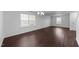 Bright living room featuring a window, neutral walls, and modern flooring at 6013 Shelane Ct, Raleigh, NC 27610
