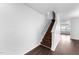 Interior staircase with wood steps, white walls, and dark floors leading upstairs at 6013 Shelane Ct, Raleigh, NC 27610