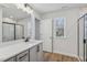 Well-lit bathroom with a modern vanity, large mirror, and a view through the window at 624 Brittany Ct, Durham, NC 27703