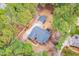 Overhead view of a property with a tree-lined lot, driveway, and detached garage at 6709 Windchase Dr, Rocky Mount, NC 27803