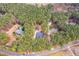 Aerial view of several houses with lush trees, detached garage, and circular driveway at 6709 Windchase Dr, Rocky Mount, NC 27803
