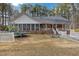 Expansive backyard featuring play equipment, lawn, and screened porch at 6709 Windchase Dr, Rocky Mount, NC 27803